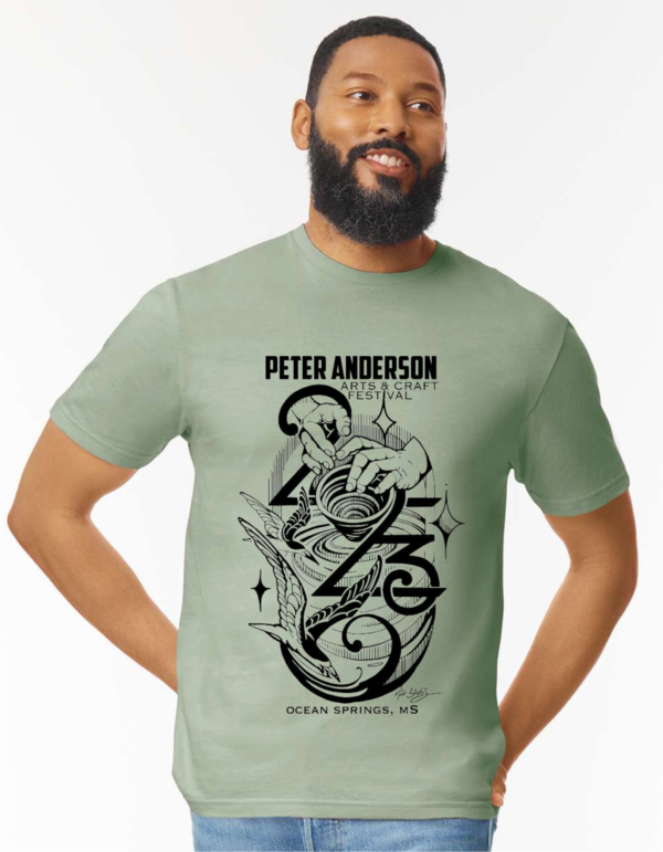 Bearded man wears a Sage green short sleeve T-shirt with a custom festival design.